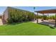 Lush backyard featuring artificial lawn, desert plants, and covered patio area at 3512 S Elm St, Tempe, AZ 85282