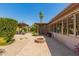 Backyard featuring a covered patio, fire pit, mature landscaping, and artificial lawn at 3512 S Elm St, Tempe, AZ 85282