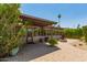 Exterior view of backyard featuring covered patio, fire pit, and manicured plants and shrubbery at 3512 S Elm St, Tempe, AZ 85282