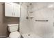 Modern bathroom featuring a walk-in shower with white marble tiling, sleek fixtures, and a toilet at 3512 S Elm St, Tempe, AZ 85282