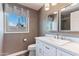 Bright bathroom featuring a white vanity with double mirrors and a view to the outside at 3512 S Elm St, Tempe, AZ 85282