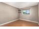 Bright bedroom with wood floors, base molding, and a window with blinds, providing natural light and privacy at 3512 S Elm St, Tempe, AZ 85282