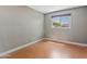 This bedroom features wood floors and a window providing a view of the outdoors at 3512 S Elm St, Tempe, AZ 85282