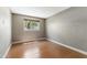 This bedroom features wood floors, and a window providing plenty of natural light at 3512 S Elm St, Tempe, AZ 85282
