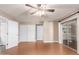 Spacious bedroom with wood flooring, a ceiling fan, closet space, and a sliding glass door to the patio at 3512 S Elm St, Tempe, AZ 85282