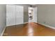 This bedroom features wood floors, a closet, and access to the laundry room for optimal functionality at 3512 S Elm St, Tempe, AZ 85282
