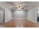 Spacious bedroom featuring wood floors, a ceiling fan and a sliding glass door leading to the backyard at 3512 S Elm St, Tempe, AZ 85282