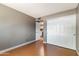 This bedroom features wood floors, a closet, and access to the laundry room at 3512 S Elm St, Tempe, AZ 85282