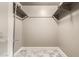 Walk-in closet with tile floors and open shelving and hanging rods for organizing clothes and accessories at 3512 S Elm St, Tempe, AZ 85282