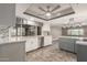 Well-lit kitchen featuring white cabinets, stainless steel appliances, and a tile backsplash, with a modern ceiling fan and light fixtures at 3512 S Elm St, Tempe, AZ 85282