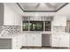 Bright kitchen with white cabinetry, granite countertops, stainless steel appliances, and tile backsplash at 3512 S Elm St, Tempe, AZ 85282