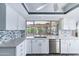 Modern kitchen features bright cabinets, stainless steel appliances, and a view of the backyard at 3512 S Elm St, Tempe, AZ 85282