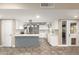 Kitchen with white cabinetry, stainless steel appliances, a center island, and backyard access at 3512 S Elm St, Tempe, AZ 85282
