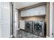 Convenient laundry room with modern washer and dryer units, ample counter space, and stylish cabinets at 3512 S Elm St, Tempe, AZ 85282