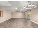 Large living room featuring tile flooring, ceiling fan, neutral paint, and backyard access at 3512 S Elm St, Tempe, AZ 85282