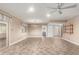 Open-concept living room with tile flooring, ceiling fan, neutral paint, and backyard access at 3512 S Elm St, Tempe, AZ 85282