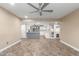 Open living space flows into the kitchen with white cabinetry, a center island and stainless steel appliances at 3512 S Elm St, Tempe, AZ 85282
