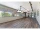 Enclosed patio featuring light colored wood floors, neutral walls, fan and chandelier at 3512 S Elm St, Tempe, AZ 85282