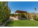 Backyard patio featuring artificial turf, drought resistant landscaping, and covered pergola at 3512 S Elm St, Tempe, AZ 85282