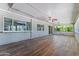 Bright and airy enclosed patio, featuring wood floors, fan, and expansive window views at 3512 S Elm St, Tempe, AZ 85282