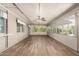 Bright sun room with ceiling fan, wood flooring, and lots of windows providing lots of natural light at 3512 S Elm St, Tempe, AZ 85282