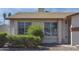 Exterior shot of a cozy home featuring well-placed windows and mature shrubs at 3519 W Libby St, Glendale, AZ 85308