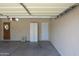 Open garage with pedestrian door and room for multiple storage cabinets at 3519 W Libby St, Glendale, AZ 85308