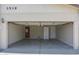 Spacious two car garage featuring storage cabinets and a pedestrian door at 3519 W Libby St, Glendale, AZ 85308