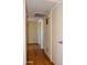 Neutral hallway with hardwood flooring and multiple doors at 3519 W Libby St, Glendale, AZ 85308