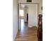 Hallway leading to multiple rooms with wood flooring and a closet at 3519 W Libby St, Glendale, AZ 85308