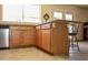 Spacious kitchen featuring an island with bar seating, natural light, and stainless steel appliances at 3519 W Libby St, Glendale, AZ 85308