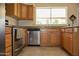 Kitchen with wood cabinets, stainless steel appliances and granite countertops at 3519 W Libby St, Glendale, AZ 85308