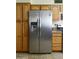 Kitchen with stainless steel refrigerator next to wood cabinets and counters at 3519 W Libby St, Glendale, AZ 85308