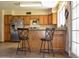 Bright eat-in kitchen featuring wood cabinets, stainless steel appliances and tile floors at 3519 W Libby St, Glendale, AZ 85308