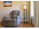 Relaxing living room featuring a recliner, standing lamp, and natural light at 3519 W Libby St, Glendale, AZ 85308