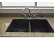 Double bowl stainless steel sink with granite countertops and neutral paint at 3519 W Libby St, Glendale, AZ 85308