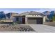 Charming single-story home with a two-car garage, desert landscaping, and stunning mountain views at 35523 N Breezy Ln, San Tan Valley, AZ 85140