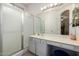 Bathroom features a spacious vanity with a large mirror and a walk-in shower with a glass door at 3742 E Sandy Way, Gilbert, AZ 85297