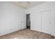 Cozy bedroom featuring plush carpet, ceiling fan, and doors for easy access at 3742 E Sandy Way, Gilbert, AZ 85297