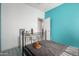 Bedroom with turquoise accent wall, tiled floors, a queen bed, and window at 3742 E Sandy Way, Gilbert, AZ 85297