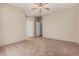 Neutral bedroom with a ceiling fan and doors leading to other areas at 3742 E Sandy Way, Gilbert, AZ 85297
