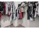 Walk-in closet with ample storage space and wooden rods with clothing at 3742 E Sandy Way, Gilbert, AZ 85297