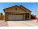 Tan home with a desert landscape including flowering bushes and a two car garage and a concrete driveway at 3742 E Sandy Way, Gilbert, AZ 85297