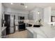 Modern kitchen featuring stainless steel appliances, stylish countertops, and sleek gray cabinetry at 3742 E Sandy Way, Gilbert, AZ 85297