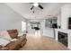 Open-concept living room with fireplace, bright lighting, and easy access to kitchen and other living spaces at 3742 E Sandy Way, Gilbert, AZ 85297