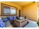Covered patio with comfortable seating and a table for outdoor enjoyment at 3742 E Sandy Way, Gilbert, AZ 85297