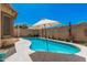 This backyard boasts a refreshing pool with desert landscaping at 3742 E Sandy Way, Gilbert, AZ 85297