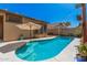 This backyard boasts a refreshing pool with an umbrella on the pool deck at 3742 E Sandy Way, Gilbert, AZ 85297