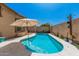 This backyard boasts a refreshing pool with patio string lights at 3742 E Sandy Way, Gilbert, AZ 85297