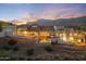 Expansive desert home with a pool, covered patio, and stunning mountain views at sunset at 4366 S Avenida De Angeles --, Gold Canyon, AZ 85118